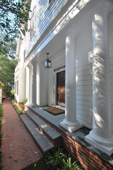 The house is entered through an impressive columned side entrance.