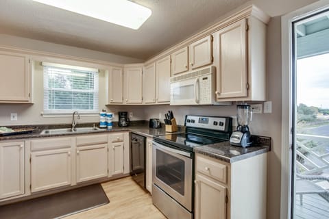 Kitchen - The kitchen offers both large and small appliances and is fully stocked with pots, pans, dishes, glassware, flatware and serving pieces for preparing your meals while staying at Summer Palace.