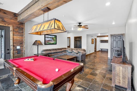 Full sized pool table in lower level living room area