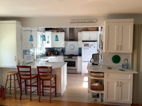 Fully furnished kitchen & bar sink. Slider to deck on right side.