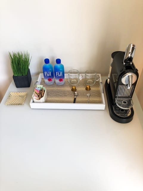 Nespresso coffee and water in bedroom

