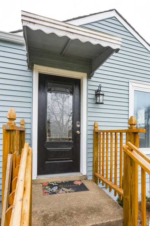 Covered front porch entrance to the home has smart lock with keypad.