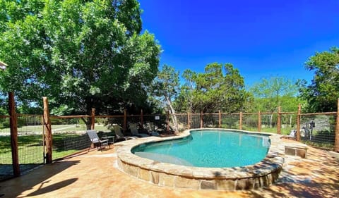 Rusty Rio - High fenced large rock patio surrounds the private raised edge swimming pool.