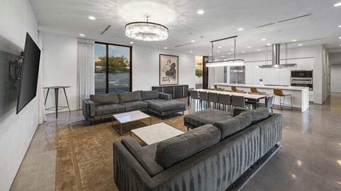 Comfortable couches & TV in living room w/ interior & exterior views