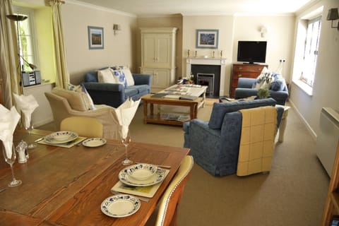 Large living/dining area with working wood burning stove, opening onto a well equipped kitchen