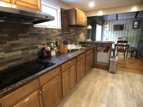 Granite countertop fully stocked kitchen with wine glass rack