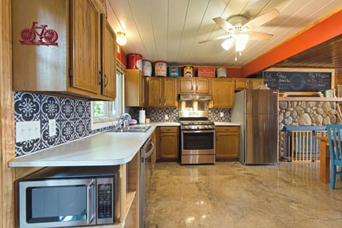 The kitchen has gas range, dishwasher, and instant hot water at the sink.