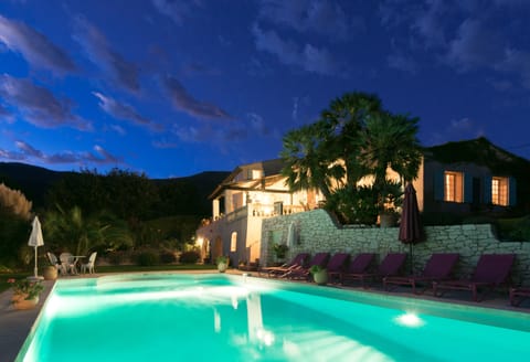 Night View of Pool, House and Mountains
