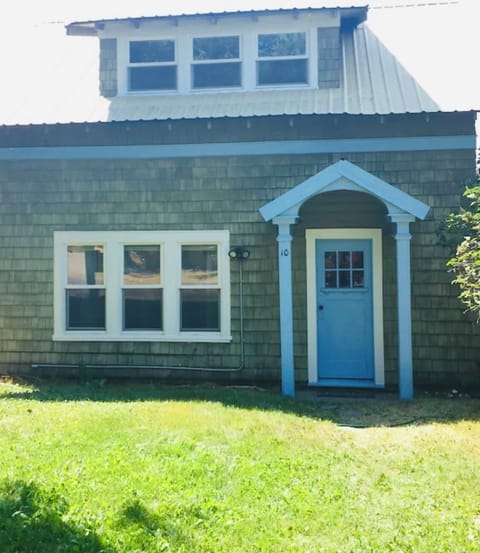 Front view of charming bungalow with decades of character in neighborhood area.