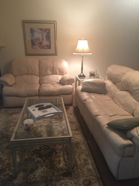 This is the living room with leather sleep sofa and love seat.