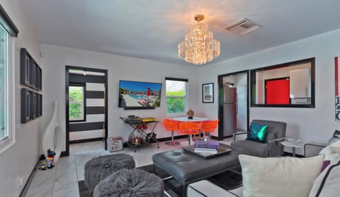 Dining room and kitchen view from living room near bedroom door. 