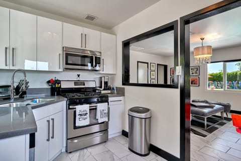 Kitchen with Gas range, looking into living room and pool beyond