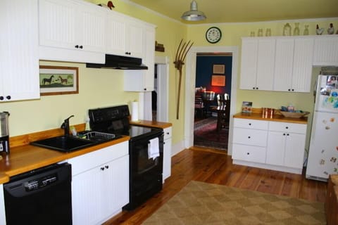Kitchen with electric range/stove, dishwasher, microwave and refrigerator.