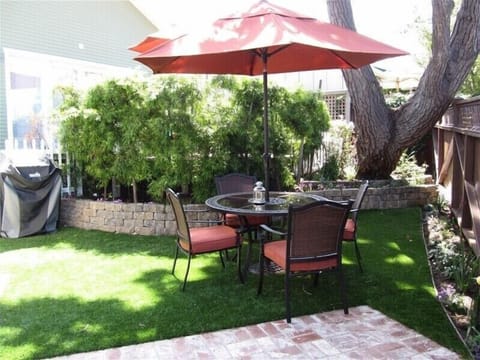 Backyard of cottage with BBQ