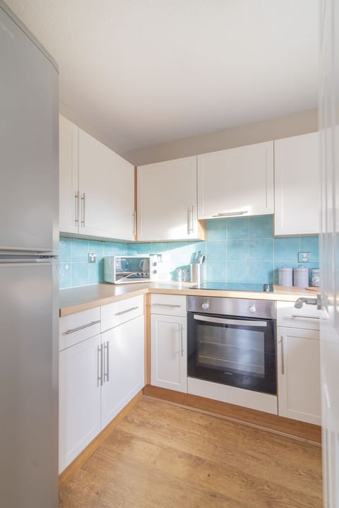Modern fully fitted kitchen with washing machine 