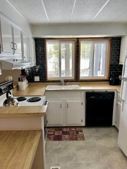 Refrigerators in kitchen and entry hall for plenty of cold storage