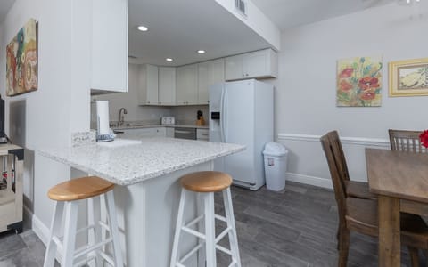 Enjoy preparing meals in this stylish kitchen, featuring sleek countertops, stainless appliances, and a welcoming dining area