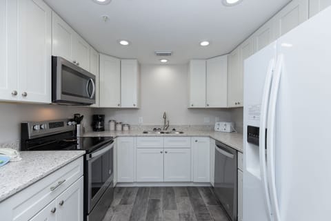 Prepare meals in this sleek kitchen, featuring stainless appliances, ample counter space, and stylish cabinetry