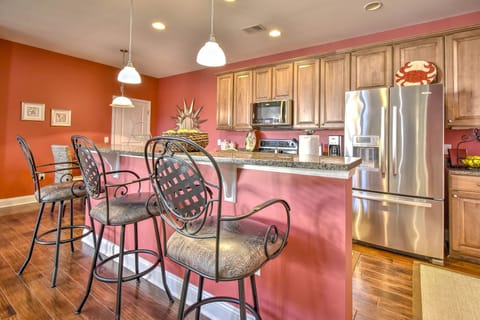 Well-equipped kitchen with counter seating and two dining areas