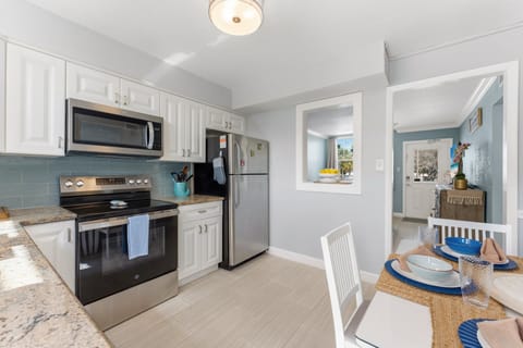 Our full kitchen Features stainless steel appliances including large fridge, stove, oven, blender and  microwave (Note: no dishwasher).