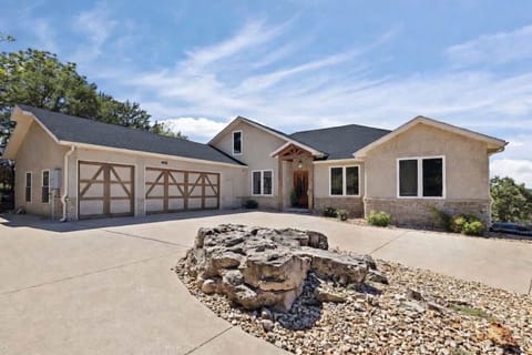 Front of the house with a large driveway.