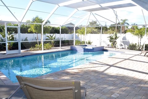 Fenced and screened in heated pool and spa