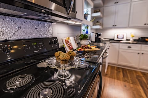 Top appliances and necessary cooking and serving utensils are provided.