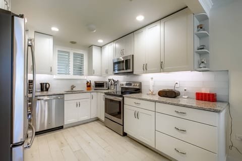 New stainless kitchen stocked with pots and pans for the chef in your family.