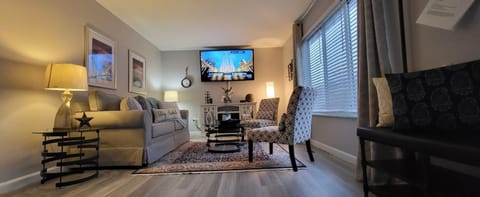 Spacious living room with a queen size pull out sofa bed and fireplace. 