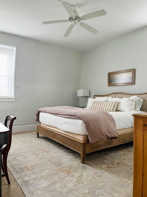 King bedroom with large closet, dresser, desk, full length mirror