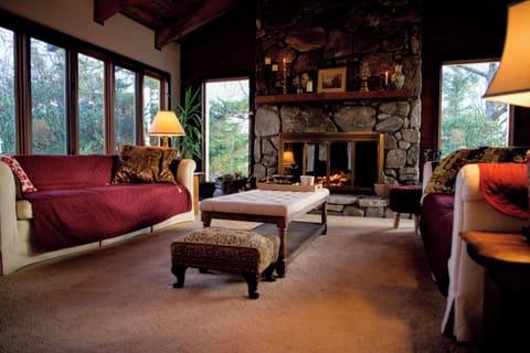 Main living room with wood burning fireplace.