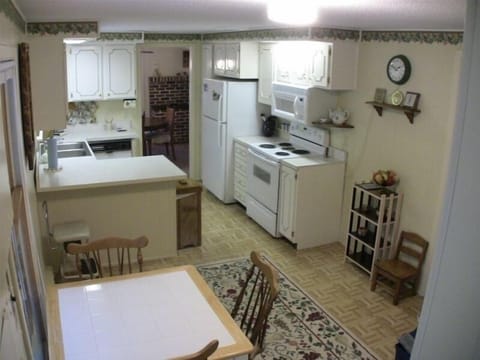 breakfast nook in the foreground, galley kitchen and dining room in the distance