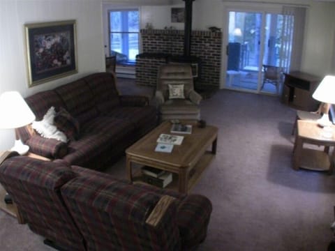 The living room with the gas stove on the brick hearth.