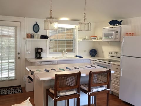 Cozy and cute kitchen opens to screened porch