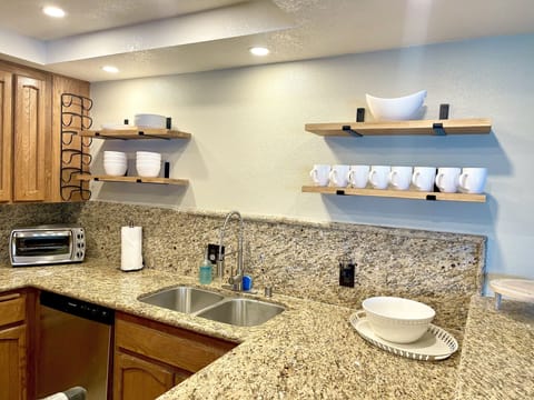 Kitchen area with gas stove, dish washer and microwave.