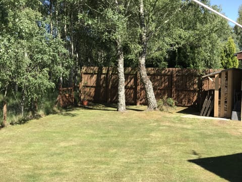 Large flat garden with table and chairs. 