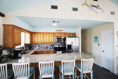 The long breakfast bar has 5 bar stools for dining