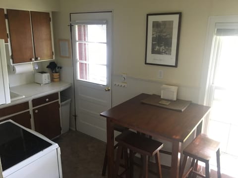 Rear/side entrance in kitchen leads to deck and exterior stairs