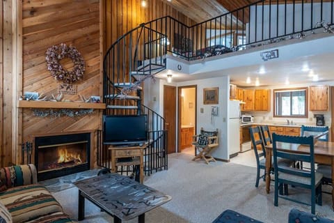 Living Room with Wood Burning Fireplace and Flat Screen TV