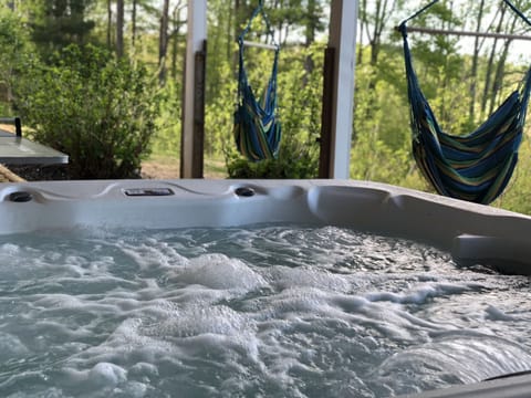 7 seat hot tub. Swing chairs overlooking the lake 
