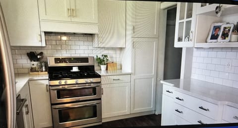 Kitchen with entry to garage and basement.  Gas stove and double oven. 