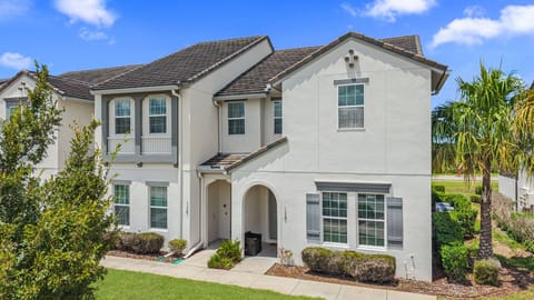 Welcome to this stylish Mediterranean-inspired home with crisp white stucco, tropical landscaping, and beautiful curb appeal.