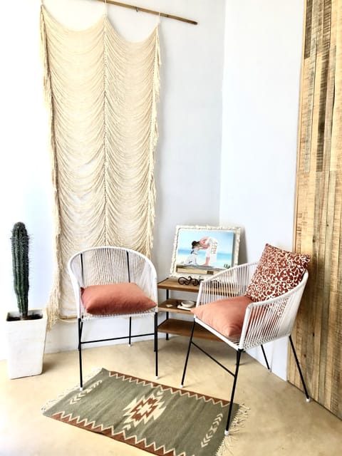Seating area in our Master Bedroom. Cactus, Mexican woven rugs + wall hangings.