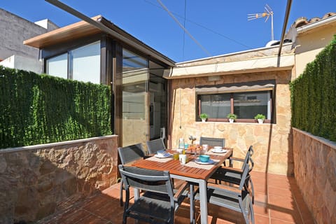 Beautiful terrace at Can Xus, a charming stone house in Mallorca's old town, perfect for outdoor dining.