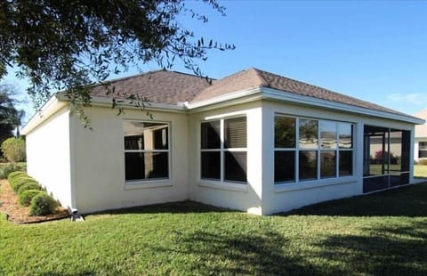 Rear view of Lynnhaven Vacation house. Florida room, screened lanai and patio.