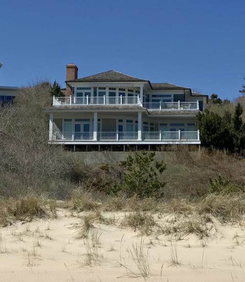 View of the house from the beach. Access to the beach is via path and boardwalk.