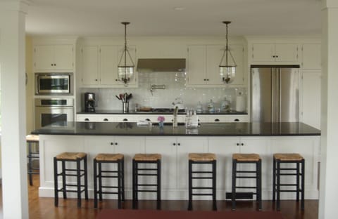 Kitchen has granite counters, stainless steel appliances. Island seats 8.