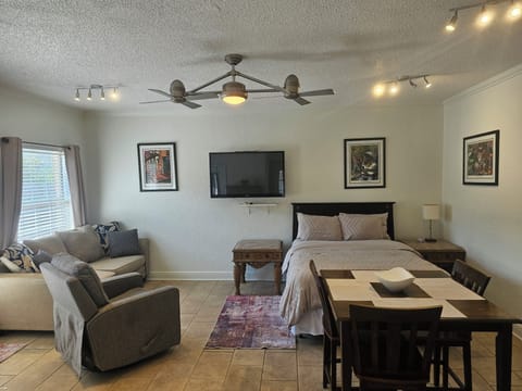 Open room with TV that swivels to face either bed or sofa.