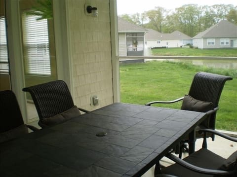 Screened in porch with seating for six and an excellent view of our pond