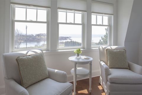 The sitting area in one of the bedrooms with a queen bed.